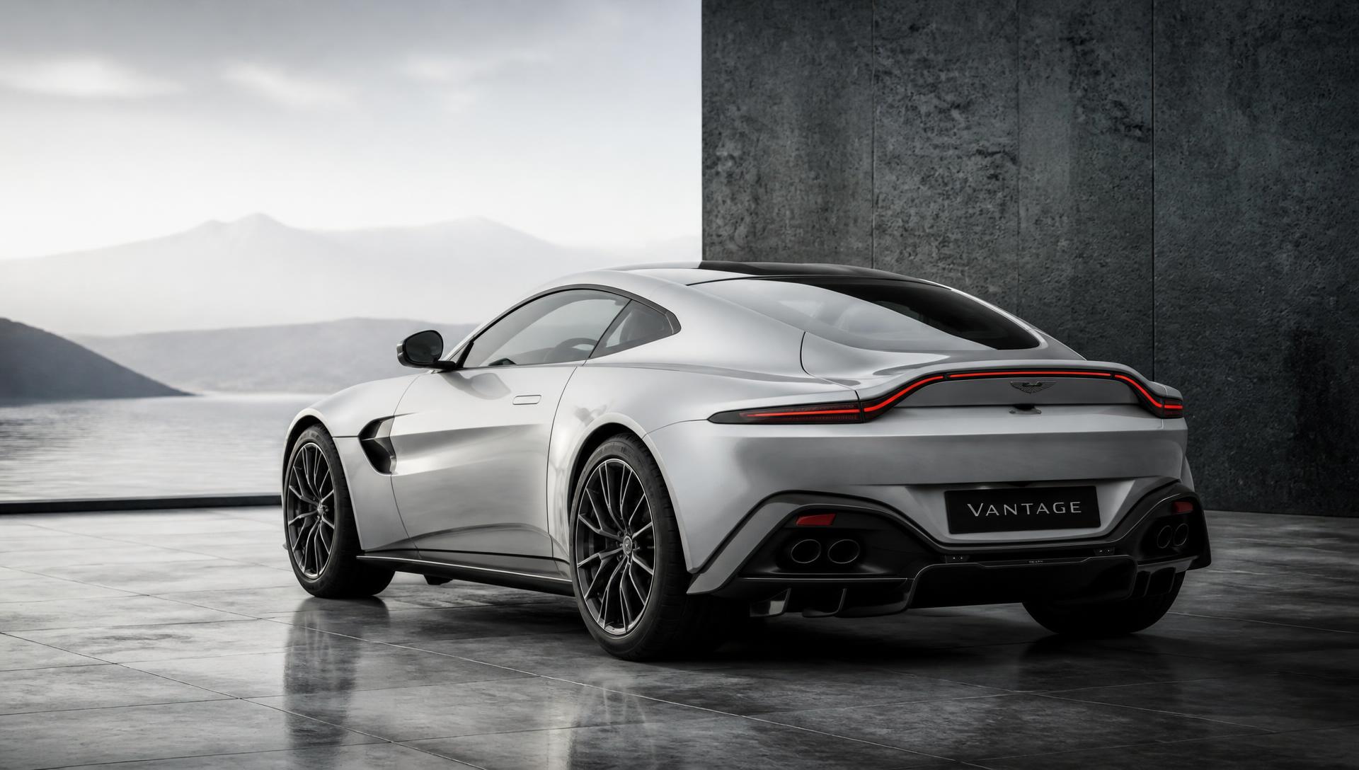 Silver luxury sports coupe parked on a concrete plaza beside still water